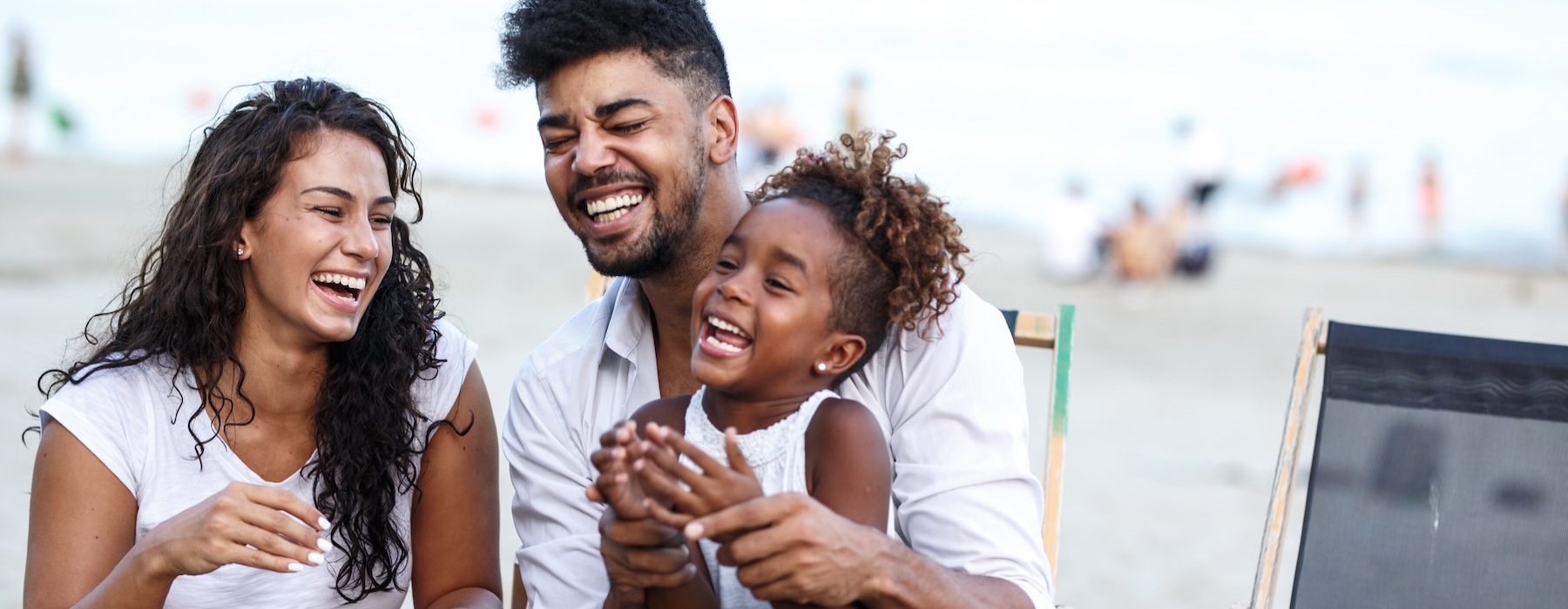 a family sitting at the beach