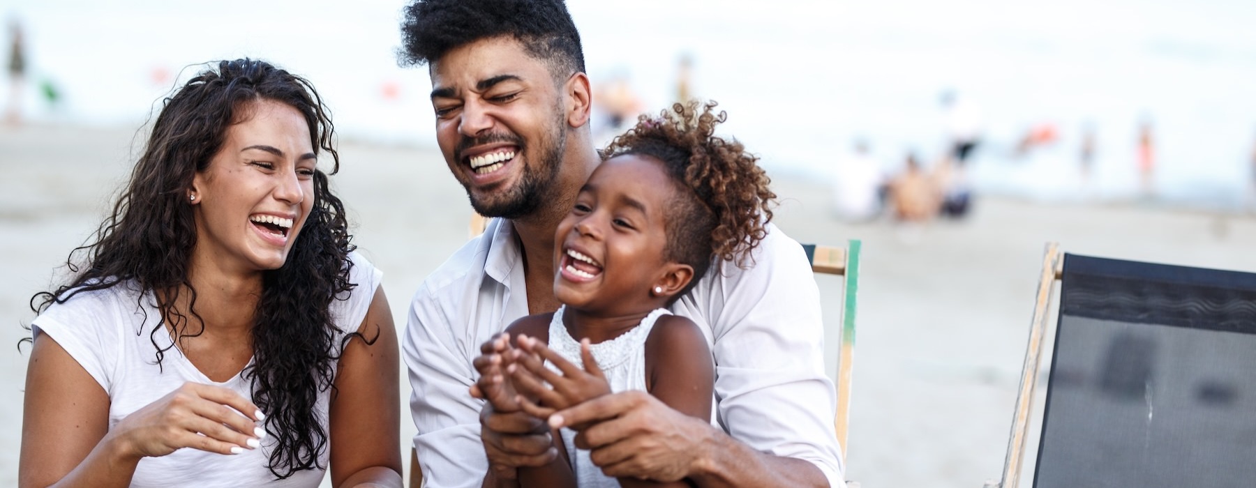 a family sitting at the beach