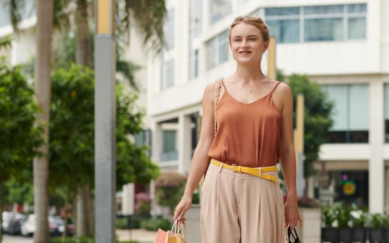 a person in a dress holding a bag